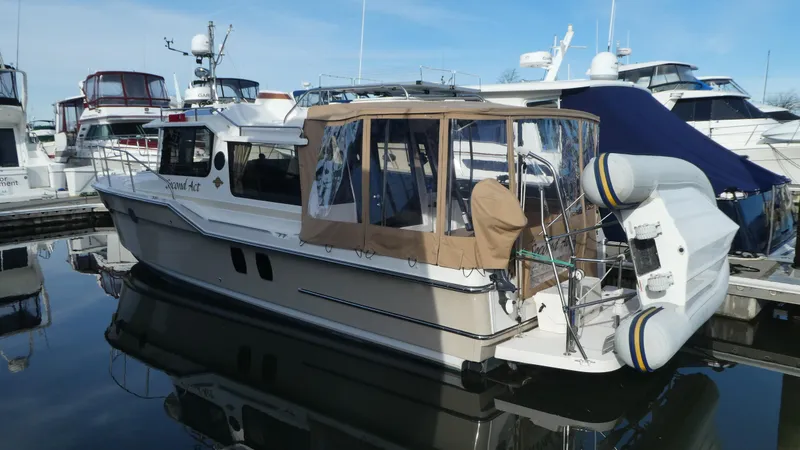 Slide: The Image of 2021 Ranger Tugs R-29 S boat docked with inflatable dinghy attached. - 2