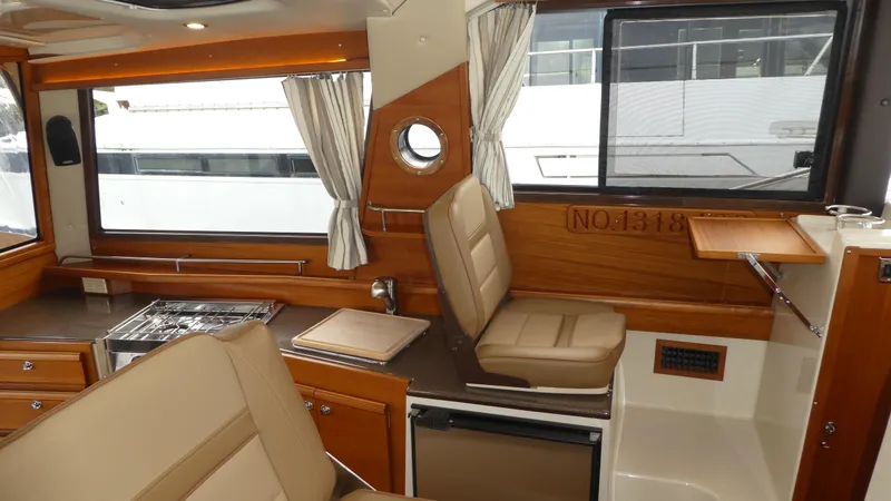 Slide: The Image of Interior of 2021 Ranger Tugs R-29 S, featuring wood accents and seating. - 20