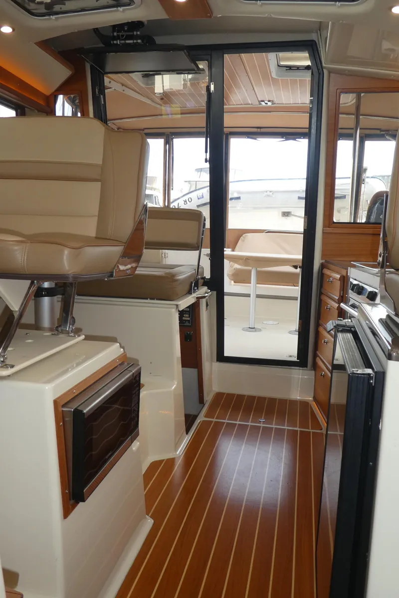Slide: The Image of Interior of 2021 Ranger Tugs R-29 S with modern seating and wood flooring. - 28