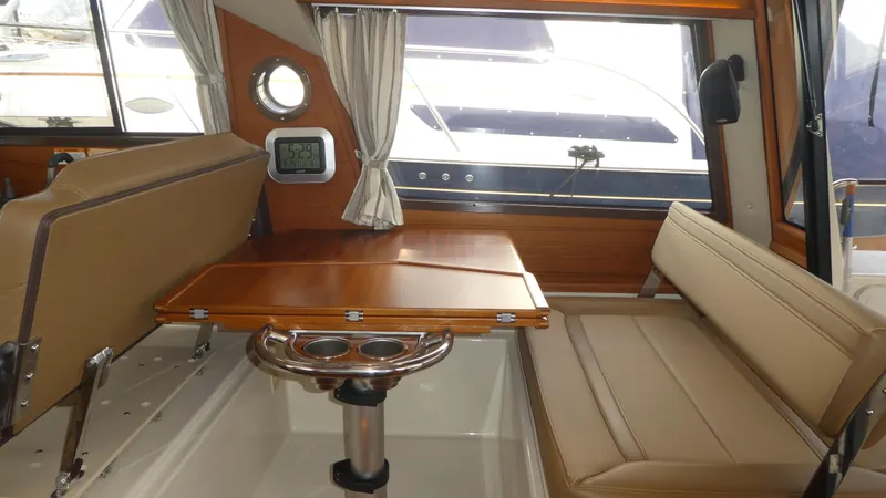 Slide: The Image of Interior of 2021 Ranger Tugs R-29 S with seating and wooden table. - 32