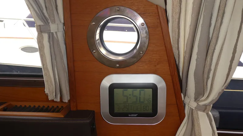 Slide: The Image of Porthole and digital clock inside 2021 Ranger Tugs R-29 S boat cabin. - 33