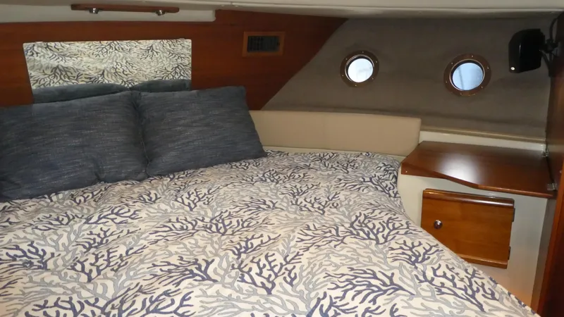 Slide: The Image of Cozy bedroom interior of 2021 Ranger Tugs R-29 S with nautical-themed bedding. - 38