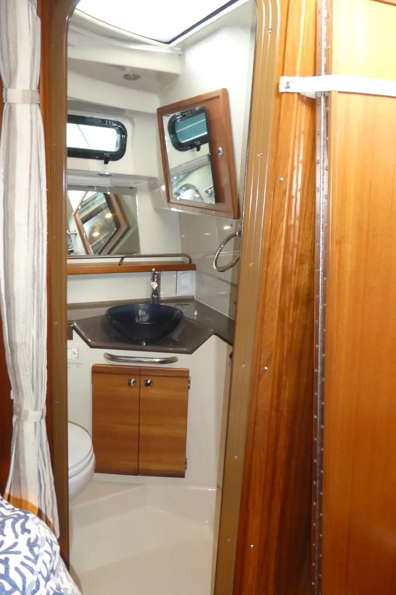 Slide: The Image of 2021 Ranger Tugs R-29 S bathroom with wood accents and modern fixtures. - 43