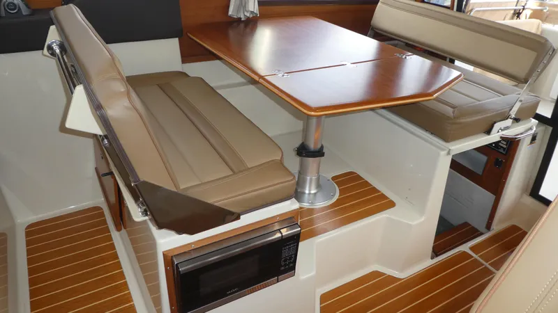 Slide: The Image of 2021 Ranger Tugs R-29 S interior with dining area and wood accents. - 48