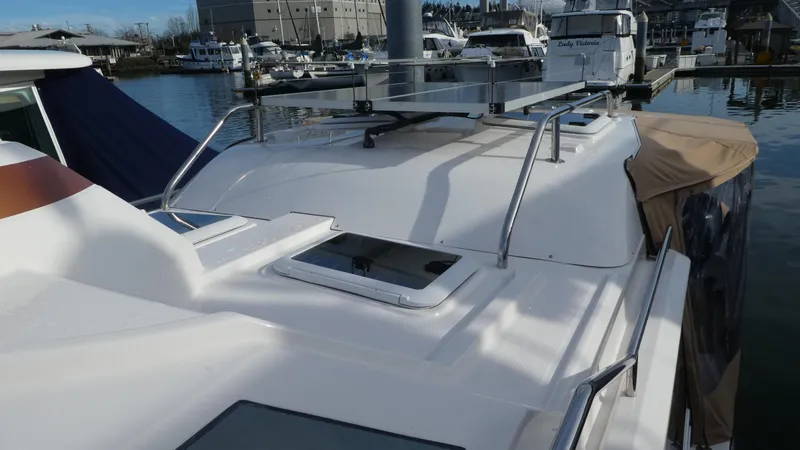 Slide: The Image of 2021 Ranger Tugs R-29 S boat roof with solar panels in marina setting. - 5