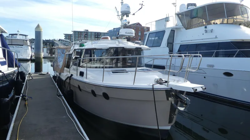 Slide: The Image of 2021 Ranger Tugs R-29 S docked at marina, surrounded by other boats. - 6
