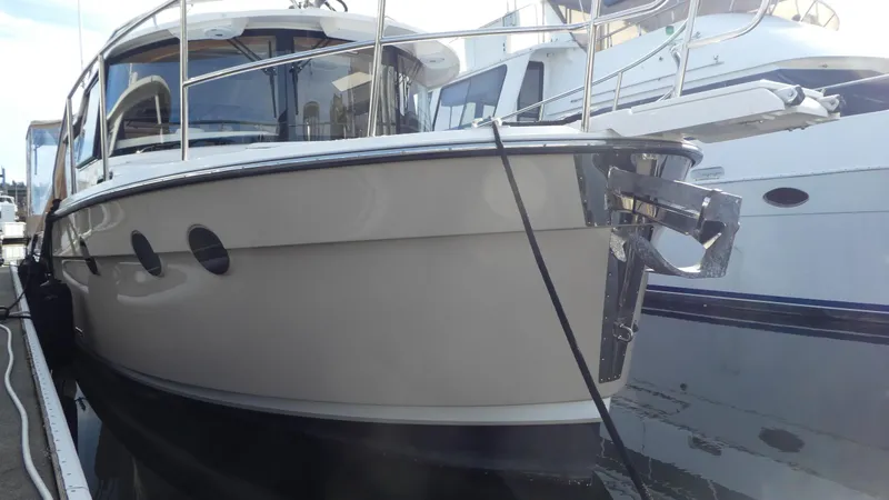 Slide: The Image of 2021 Ranger Tugs R-29 S boat docked at marina, side view. - 8