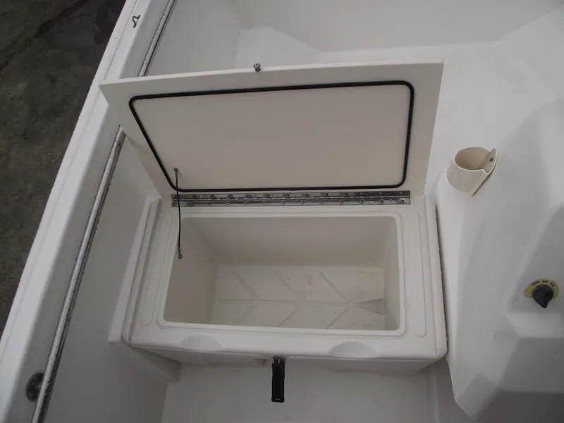 Slide: The Image of Open storage compartment on a 2010 Boston Whaler 150 Super Sport boat. - 12
