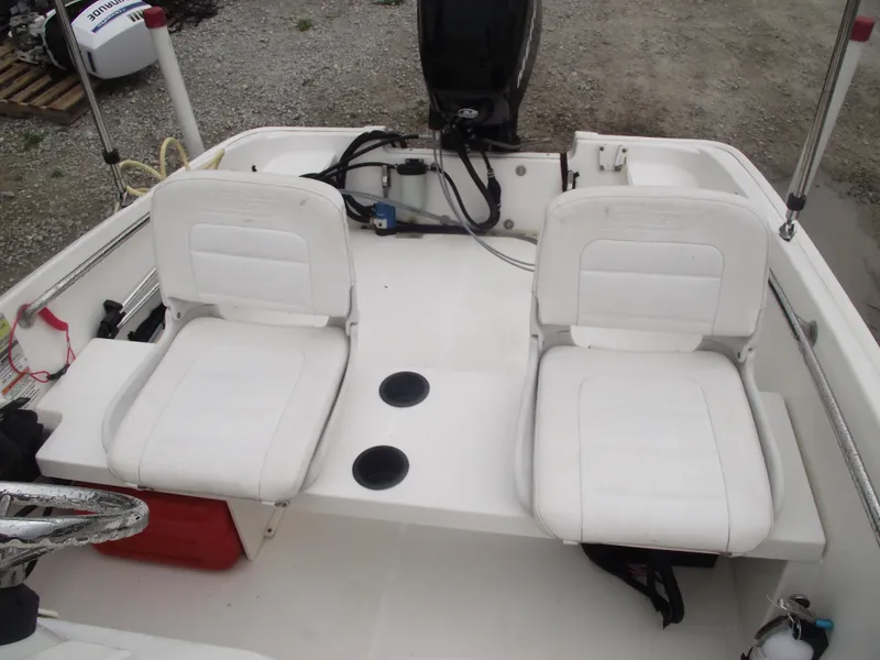 Slide: The Image of 2010 Boston Whaler 150 Super Sport boat interior with two white seats. - 14
