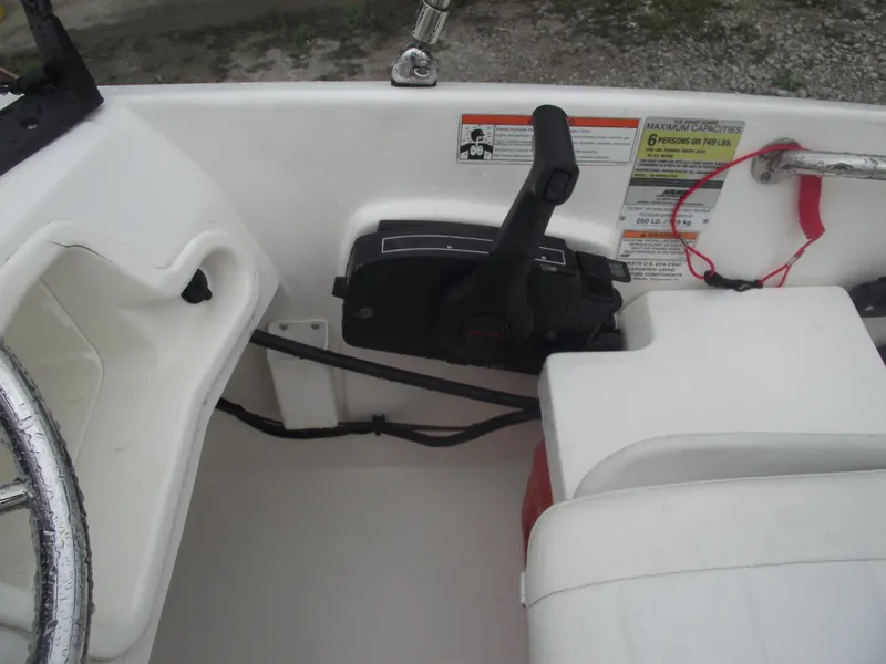 Slide: The Image of Interior of a 2010 Boston Whaler 150 Super Sport boat showing controls and seating. - 15