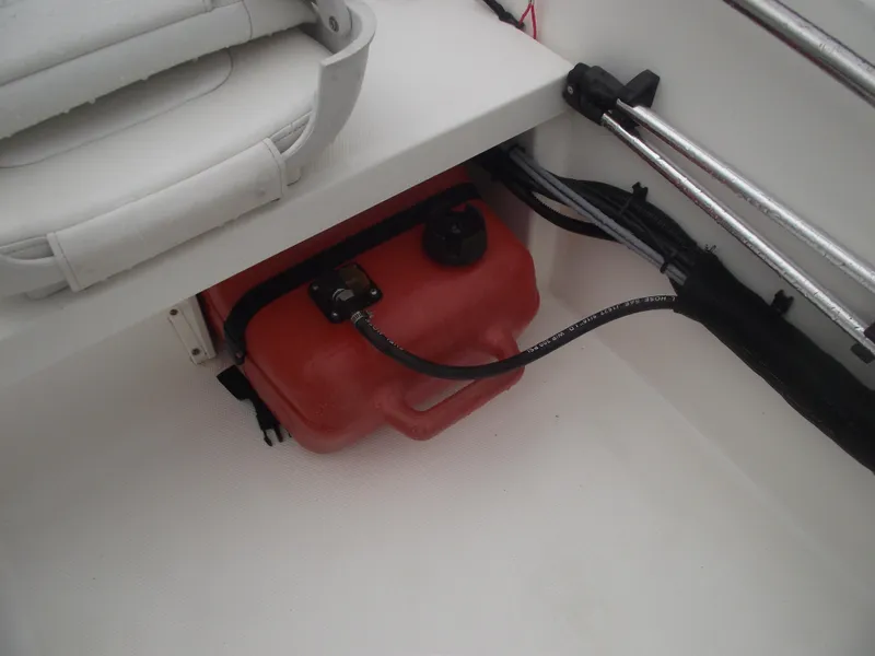Slide: The Image of 2010 Boston Whaler 150 Super Sport fuel tank and storage area. - 16