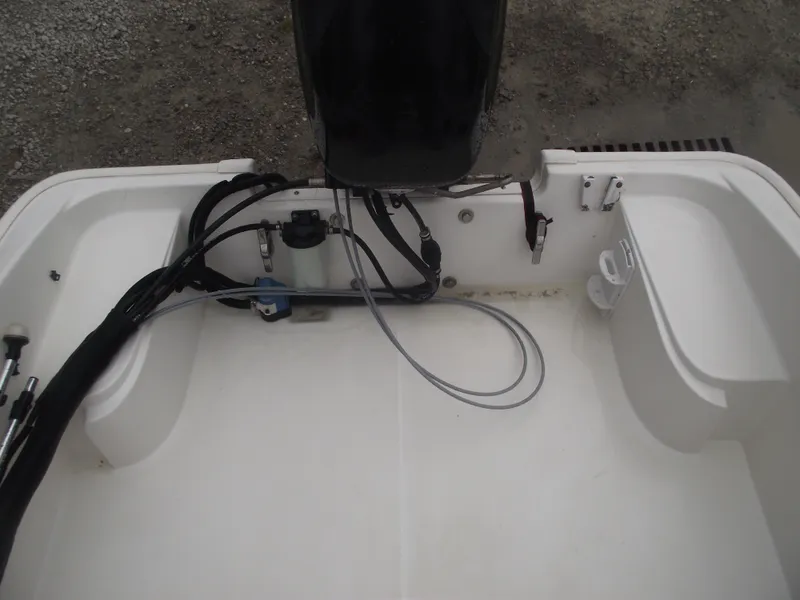 Slide: The Image of 2010 Boston Whaler 150 Super Sport boat interior with motor and wiring visible. - 18