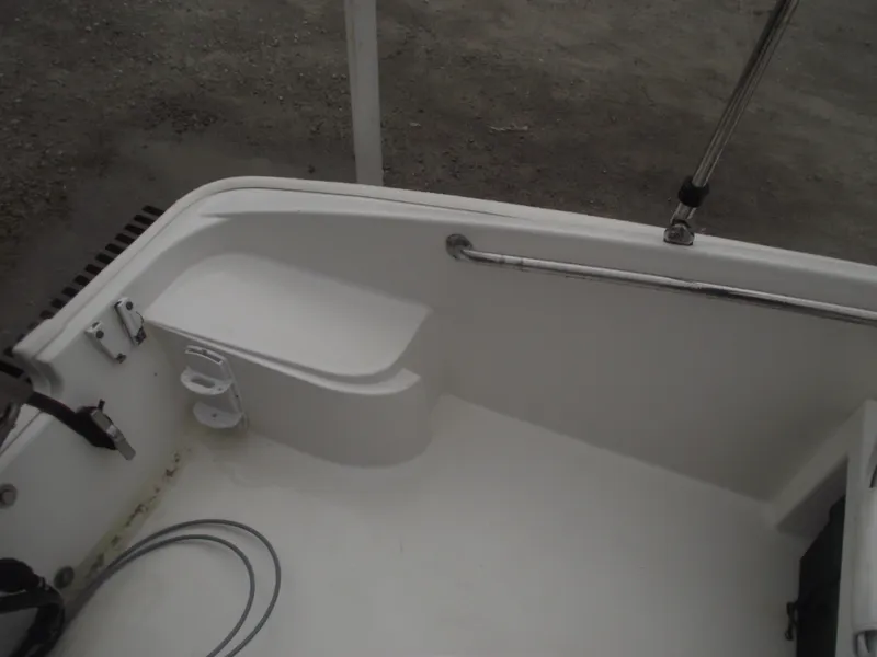 Slide: The Image of 2010 Boston Whaler 150 Super Sport boat interior with seating and railing. - 19