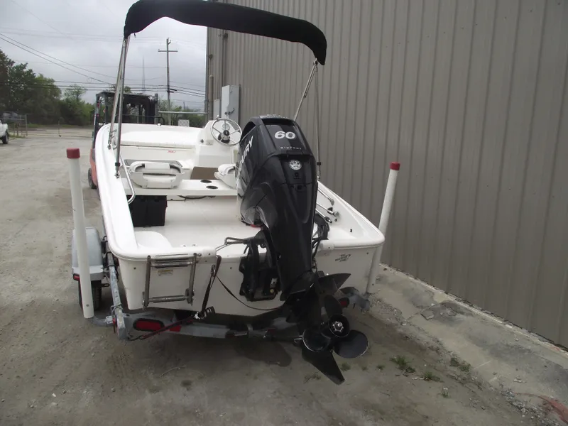 Slide: The Image of 2010 Boston Whaler 150 Super Sport boat with 60 HP outboard motor, parked on trailer. - 3