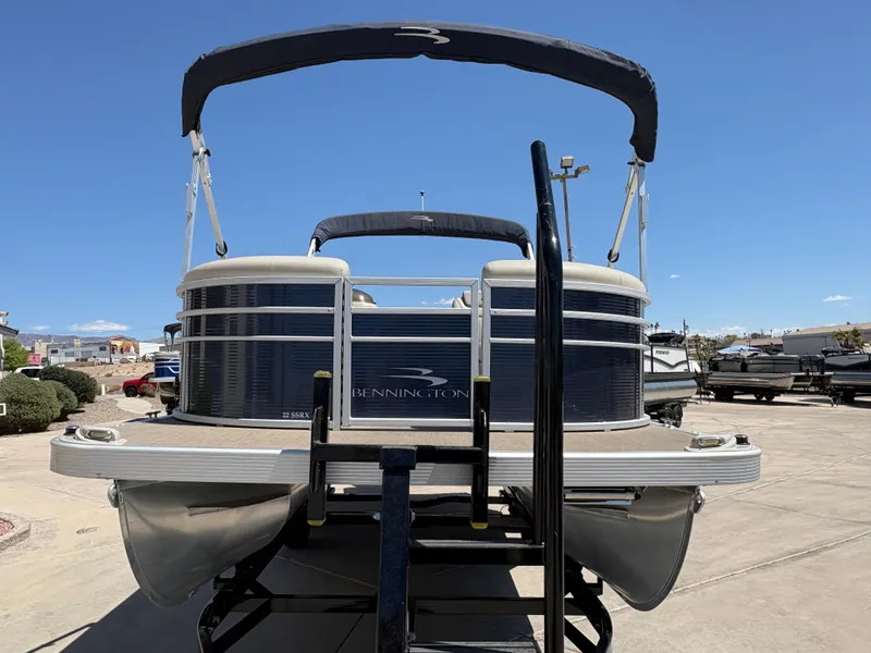 Slide: The Image of 2018 Bennington 22 SSRX pontoon boat on trailer under clear blue sky. - 1