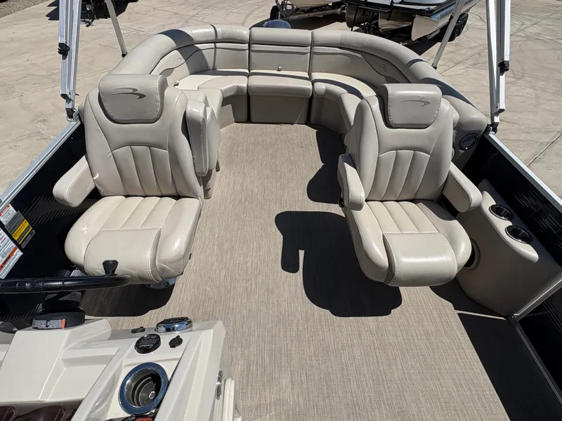 Slide: The Image of 2018 Bennington 22 SSRX boat interior with plush seating and modern dashboard. - 11
