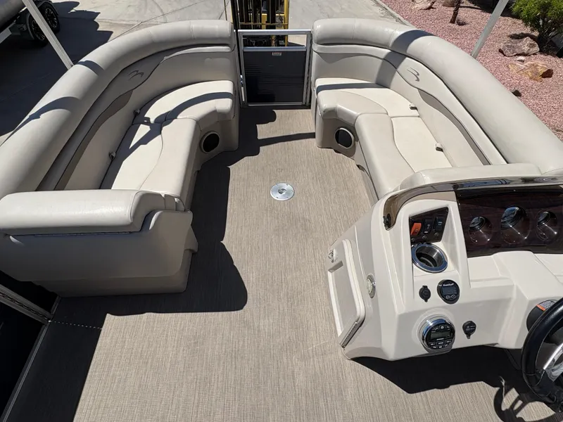 Slide: The Image of 2018 Bennington 22 SSRX pontoon boat interior with beige seating and control panel. - 12