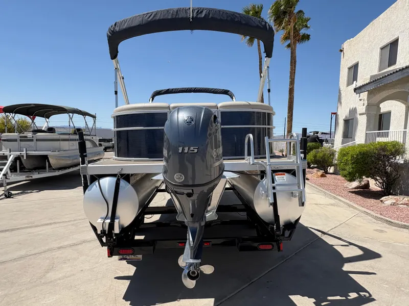 Slide: The Image of 2018 Bennington 22 SSRX pontoon boat with 115 HP engine, parked outdoors. - 4
