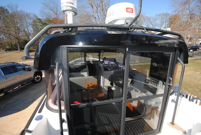 Slide: The Image of 2015 XO Boats 270 RS, exterior view, showcasing sleek design and modern navigation equipment. - 10