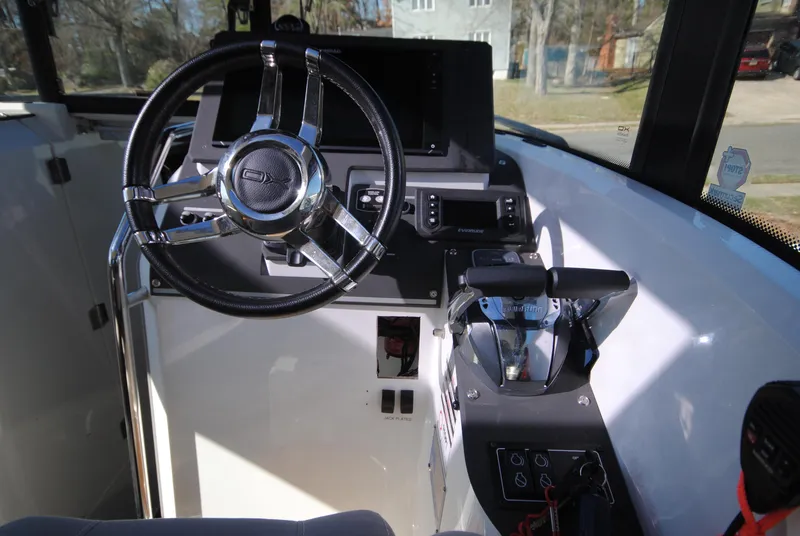 Slide: The Image of 2015 XO Boats 270 RS cockpit with steering wheel and control panel. - 14