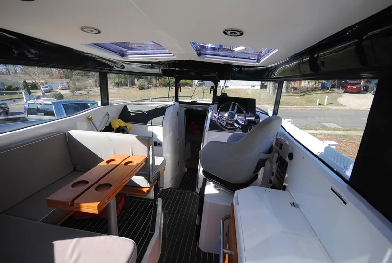 Slide: The Image of Interior of 2015 XO Boats 270 RS, featuring seating and helm, with modern design elements. - 16