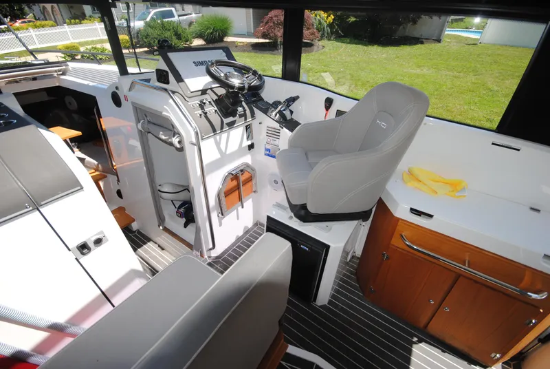 Slide: The Image of Interior of 2015 XO Boats 270 RS, featuring helm station and seating area. - 18