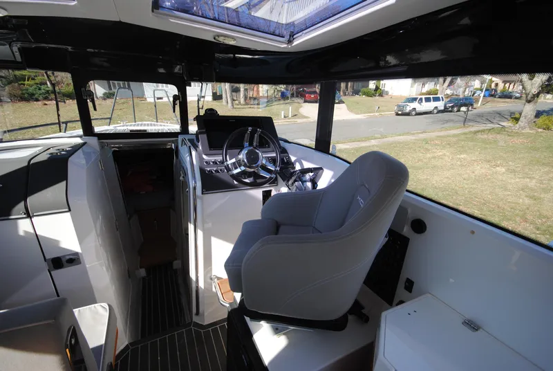 Slide: The Image of Interior of 2015 XO Boats 270 RS, featuring helm and seating area. - 19