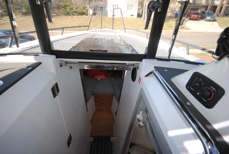 Slide: The Image of 2015 XO Boats 270 RS interior view, showcasing cabin entrance and deck layout. - 25