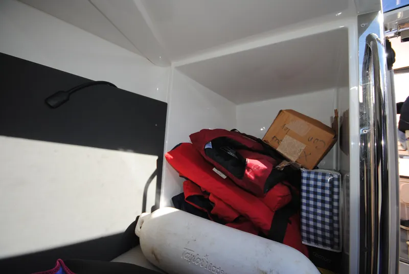 Slide: The Image of Storage compartment in a 2015 XO Boats 270 RS with life jackets and equipment. - 27