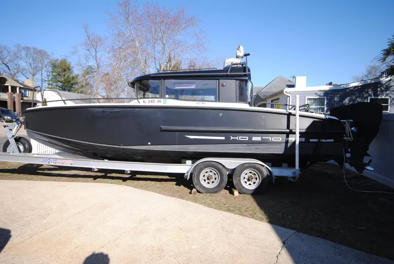Slide: The Image of 2015 XO Boats 270 RS on trailer, black hull, parked outdoors. - 3