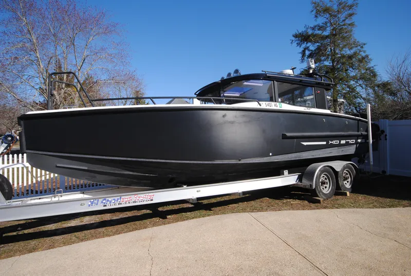 Slide: The Image of 2015 XO Boats 270 RS on trailer, black hull, parked outdoors. - 5