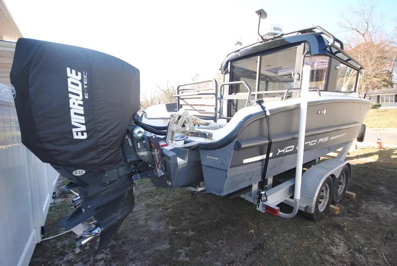 Slide: The Image of 2015 XO Boats 270 RS with Evinrude engine on trailer, parked outdoors. - 6