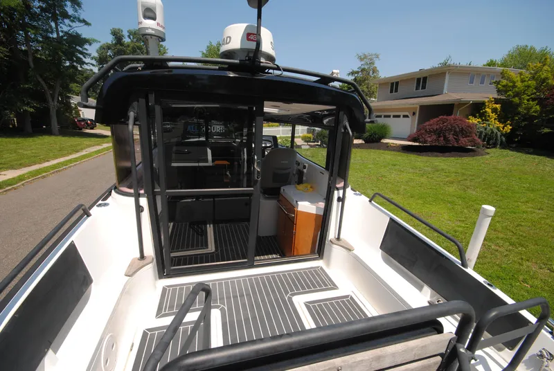 Slide: The Image of 2015 XO Boats 270 RS on driveway, showcasing interior and exterior design features. - 9