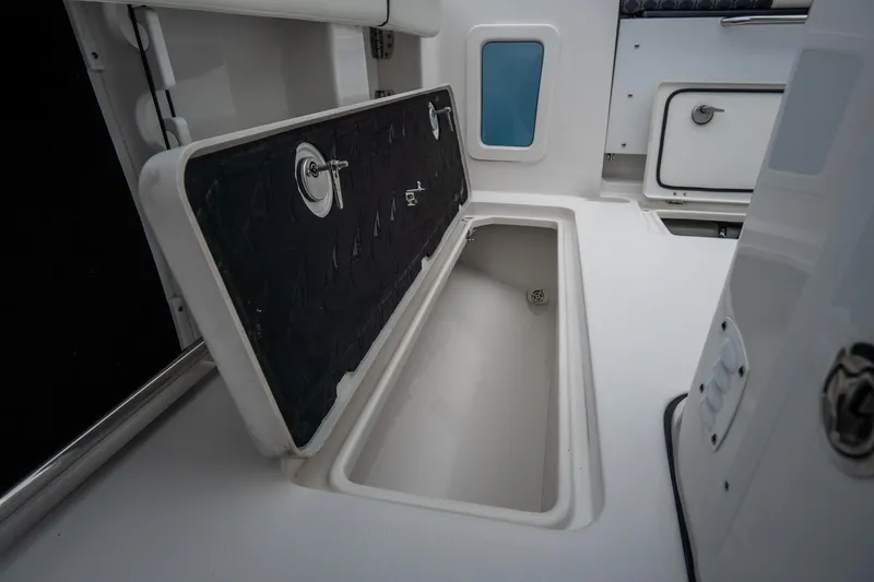 Slide: The Image of 2023 Tidewater 282cc Adventure Bluewater boat storage compartment, open and empty. - 11