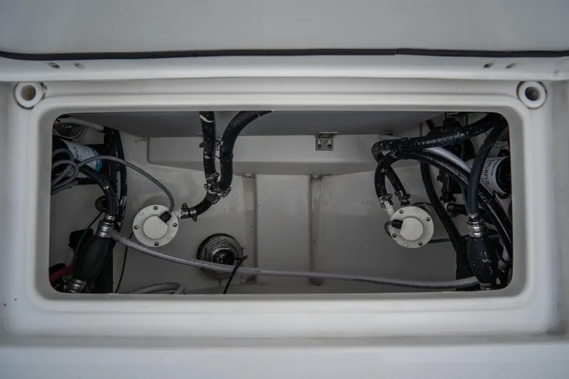 Slide: The Image of 2023 Tidewater 282cc Adventure Bluewater boat compartment with visible wiring and plumbing. - 13