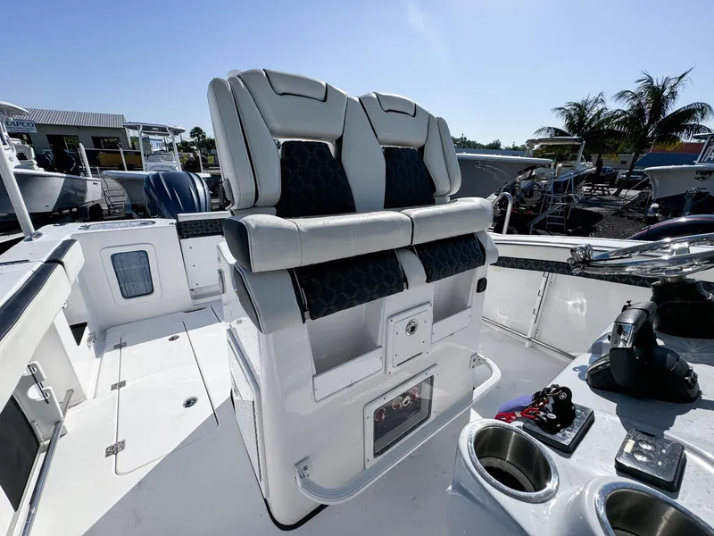 Slide: The Image of 2023 Tidewater 282cc Adventure Bluewater boat interior with dual seats and control panel. - 15