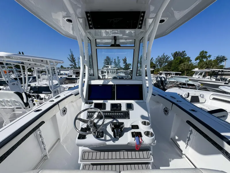 Slide: The Image of 2023 Tidewater 282cc Adventure Bluewater boat cockpit with modern controls and dual screens. - 16