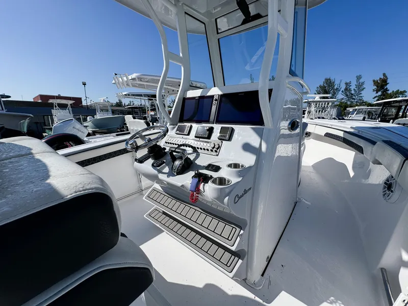Slide: The Image of 2023 Tidewater 282cc Adventure Bluewater boat cockpit with modern controls and seating. - 17