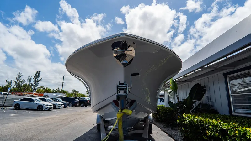 Slide: The Image of 2023 Tidewater 282cc Adventure Bluewater boat on trailer under blue sky. - 2