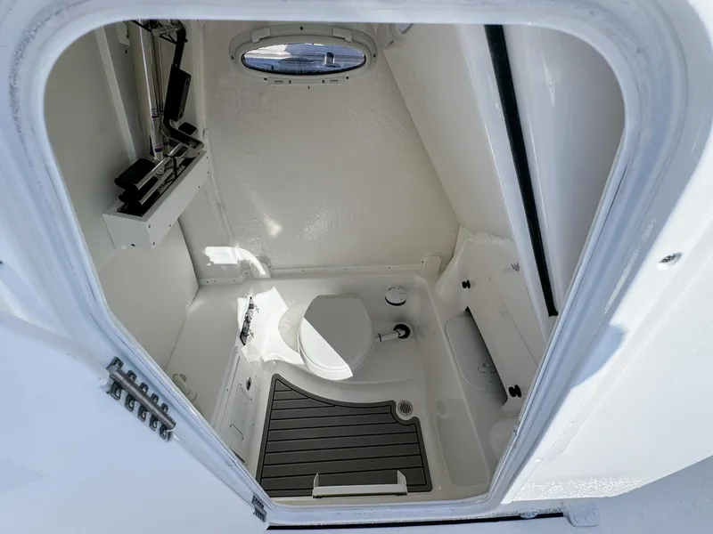 Slide: The Image of 2023 Tidewater 282cc Adventure Bluewater boat interior with compact marine toilet. - 20