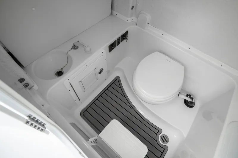 Slide: The Image of 2023 Tidewater 282cc Adventure Bluewater boat interior bathroom with toilet and sink. - 22