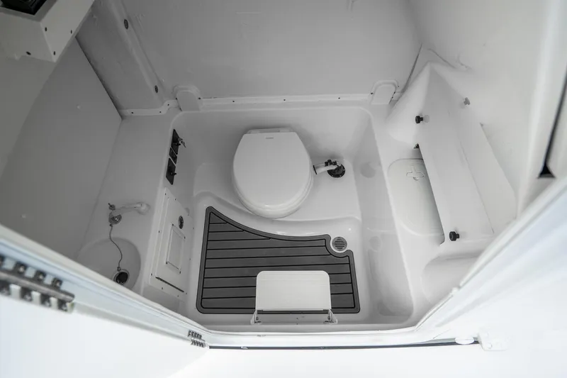 Slide: The Image of 2023 Tidewater 282cc Adventure Bluewater boat interior bathroom with toilet and storage. - 23
