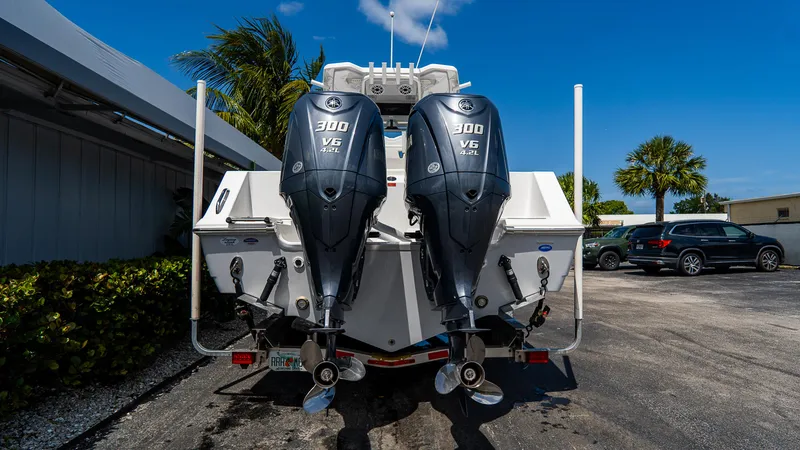 Slide: The Image of 2023 Tidewater 282cc Adventure Bluewater boat with dual 300 horsepower engines, parked outdoors. - 29