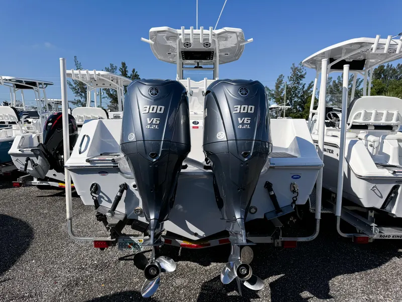Slide: The Image of 2023 Tidewater 282cc Adventure Bluewater boat with dual 300 V6 engines, parked outdoors. - 4