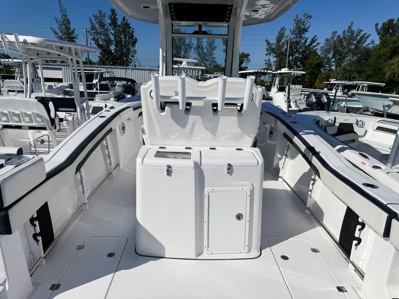 Slide: The Image of 2023 Tidewater 282cc Adventure Bluewater boat interior with sleek white design and spacious seating. - 8