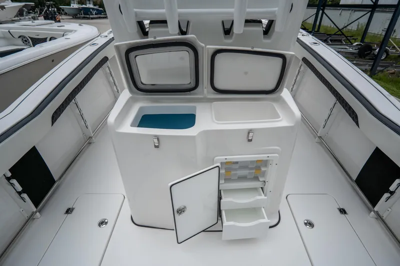 Slide: The Image of 2023 Tidewater 282cc Adventure Bluewater boat with open storage compartments and sleek deck design. - 9