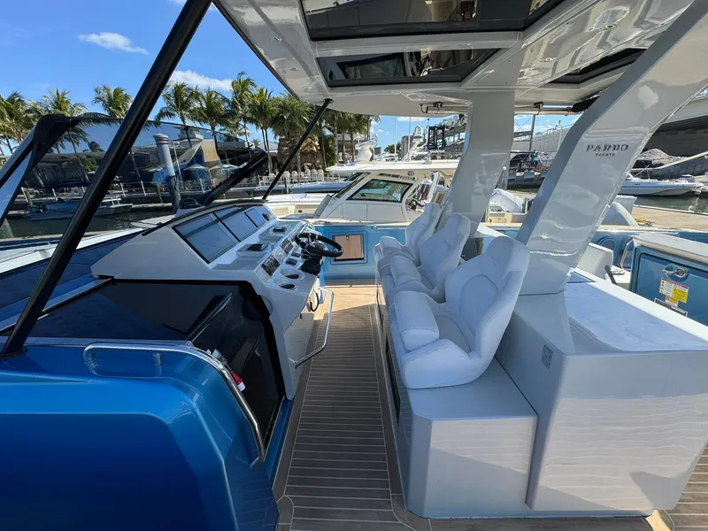 Slide: The Image of 2022 Pardo Yachts 43 interior with sleek design and modern controls, docked at marina. - 10