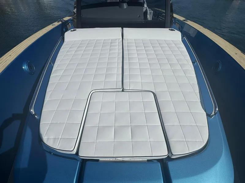 Slide: The Image of 2022 Pardo Yachts 43 with white cushioned deck, sleek design, and blue exterior. - 24