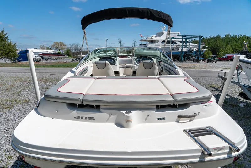 Slide: The Image of 2008 Sea Ray 205 Sport boat with open deck and seating, parked outdoors. - 10