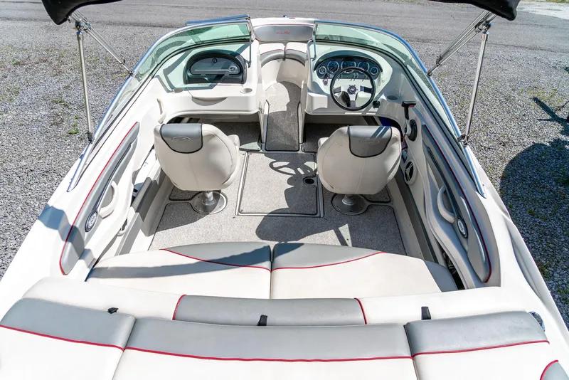 Slide: The Image of 2008 Sea Ray 205 Sport boat interior with seating and dashboard, viewed from above. - 11